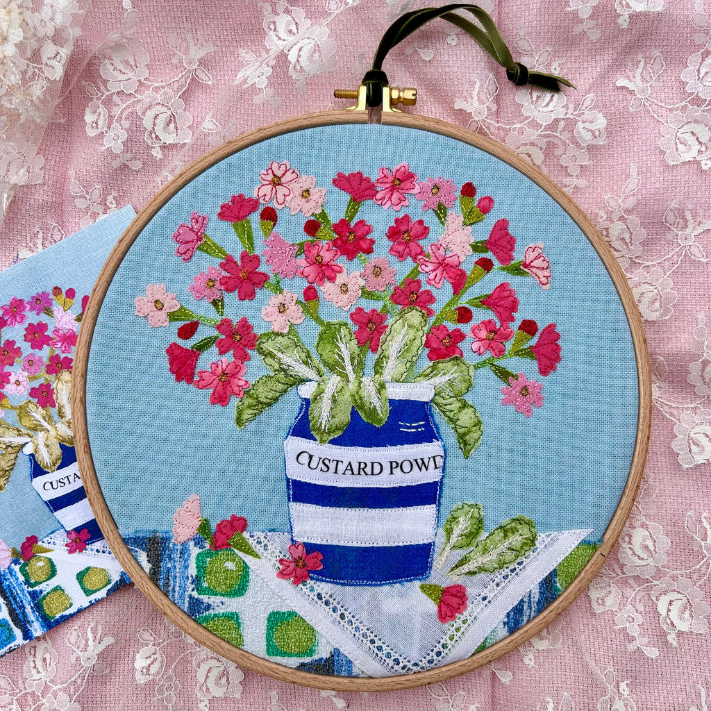 Hooped Picture - Embroidered Birds-eye primrose in a custard powder pot.