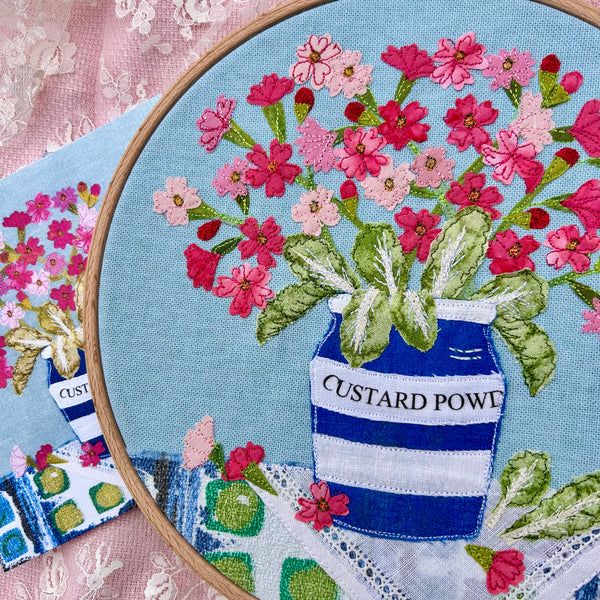 Hooped Picture - Embroidered Birds-eye primrose in a custard powder pot.